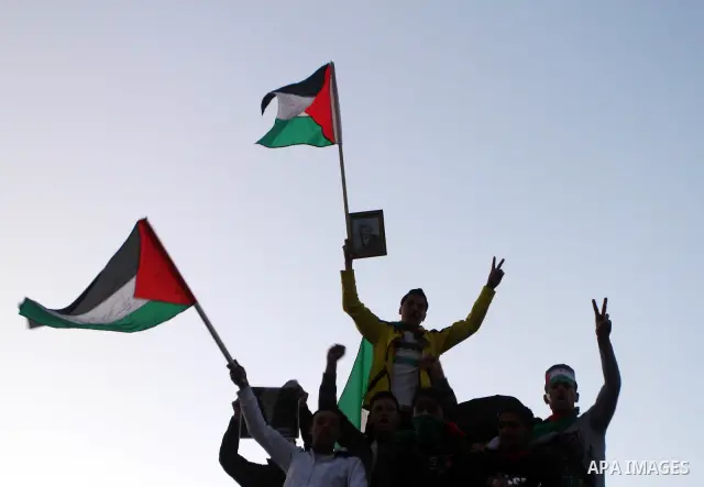 Palestinians participate in a march calling for a reconciliation between the rival Palestinian leading factions Hamas in Gaza and Fatah in the West Bank, in Gaza City, Monday, March 14, 2011. Photo by Ashraf Amra