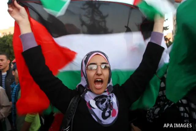 Palestinians participate in a march calling for a reconciliation between the rival Palestinian leading factions Hamas in Gaza and Fatah in the West Bank, in Gaza City, Monday, March 14, 2011. Photo by Ashraf Amra