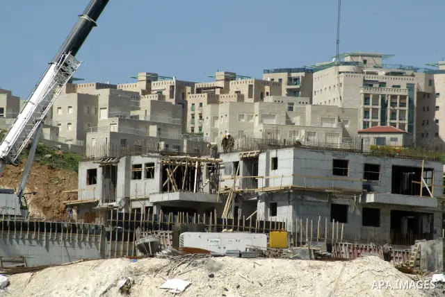 Palestinian labourers work in an Israeli settlement of Harmon Hanatziv in East jerusalem, Monday, March 14, 2011. The U.S. Embassy said Monday it was "deeply concerned" by Israel's plans to build hundreds of new homes in...