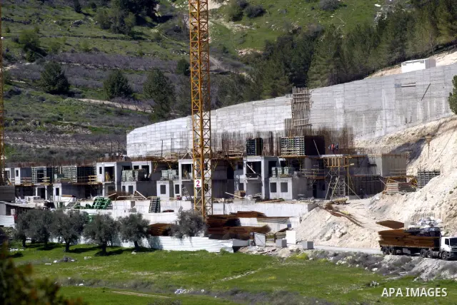 Palestinian labourers work in an Israeli settlement of Harmon Hanatziv in East jerusalem, Monday, March 14, 2011. The U.S. Embassy said Monday it was "deeply concerned" by Israel's plans to build hundreds of new homes in...