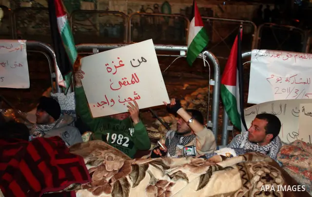 Palestinians on a hunger strike hold signs calling for national unity and an end to the political division, in reference to the bitter split between Gaza's Hamas rulers and the Fatah-dominated Palestinian Authority in th...