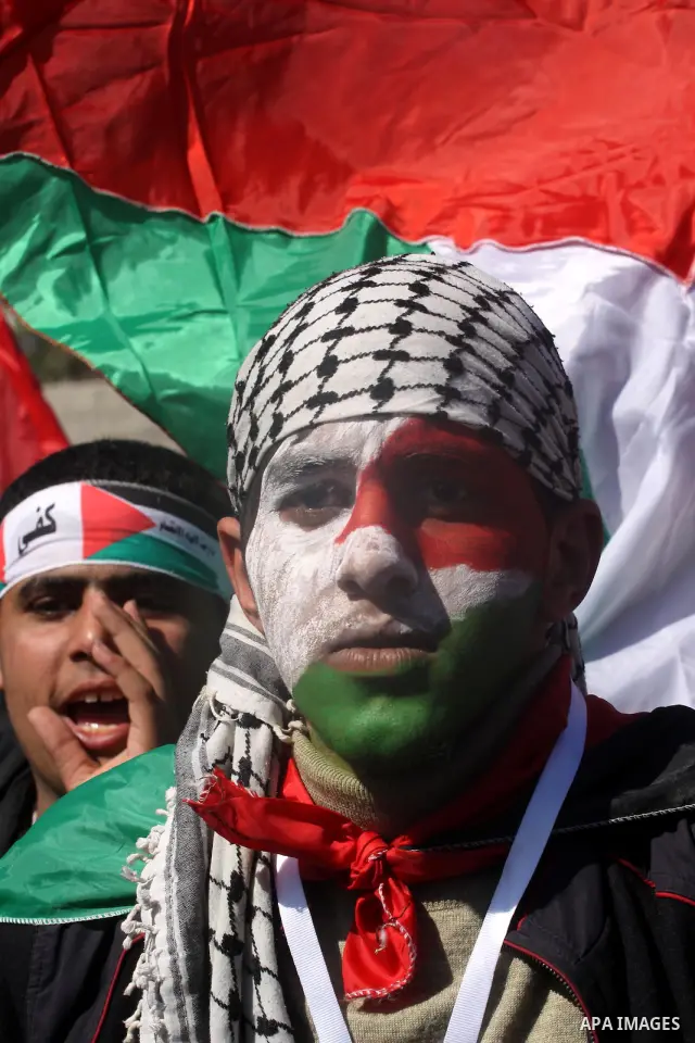 Palestinian youths take part in a rally calling for a reconciliation between the rival Palestinian leading factions Hamas in Gaza and Fatah in the West Bank, in Gaza City on March 15, 2011. Hundreds of youths demonstrate...