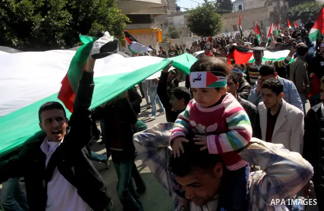 Palestinian youths take part in a rally calling for a reconciliation between the rival Palestinian leading factions Hamas in Gaza and Fatah in the West Bank, in Gaza City on March 15, 2011. Hundreds of youths demonstrate...