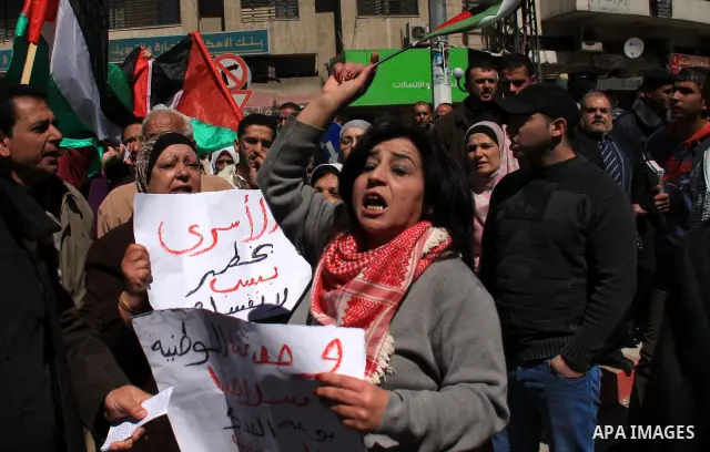 Palestinian demonstrators take part in a protest calling for Palestinian political unity between Gaza's Hamas rulers and the Fatah-dominated Palestinian Authority which rules from Ramallah, on March 15, 2011in Nablus, as...