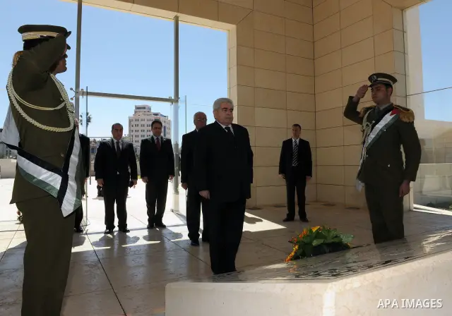 Cypriot President Dimitris Christofias lays a wreath at the tomb of the late Palestinian leader Yasser Arafat in the West Bank city of Ramallah March 15, 2011. Christofias is on an official visit to Israel and the Palest...