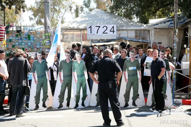 Israeli activists hold up banners in front of the Israeli Prime Minister's house during a five-minute protest calling for the release of captured Israeli soldier Sgt. Gilad Schalit in Jerusalem Tuesday, March 15, 2011. T...
