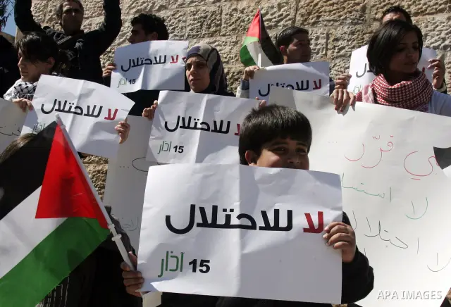 Palestinian demonstrators take part in a protest calling for Palestinian political unity between Gaza's Hamas rulers and the Fatah-dominated Palestinian Authority which rules from Ramallah, on March 15, 2011 in front of...