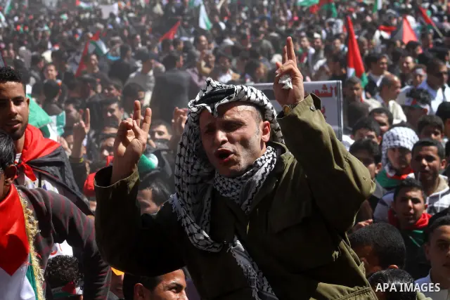 A Palestinian dressed like late Palestinian leader Yasser Arafat shouts slogans during a rally calling for Palestinian political unity between Gaza's Hamas rulers and the Fatah-dominated Palestinian Authority which rules...