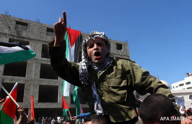 A Palestinian dressed like late Palestinian leader Yasser Arafat shouts slogans during a rally calling for Palestinian political unity between Gaza's Hamas rulers and the Fatah-dominated Palestinian Authority which rules...