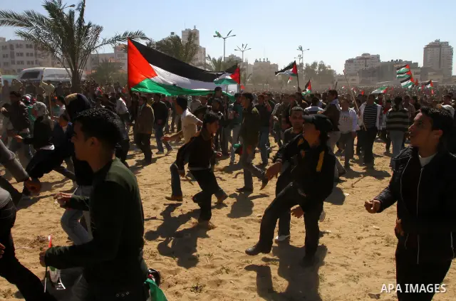 Palestinian demonstrators run during brief clashes between Hamas supporters and protestors supporting other Palestinian factions, during a rally calling for Palestinian political unity between Gaza's Hamas rulers and the...