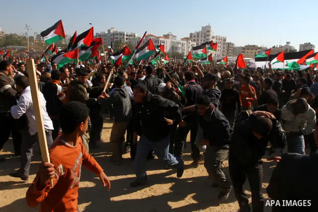 Palestinian demonstrators run during brief clashes between Hamas supporters and protestors supporting other Palestinian factions, during a rally calling for Palestinian political unity between Gaza's Hamas rulers and the...