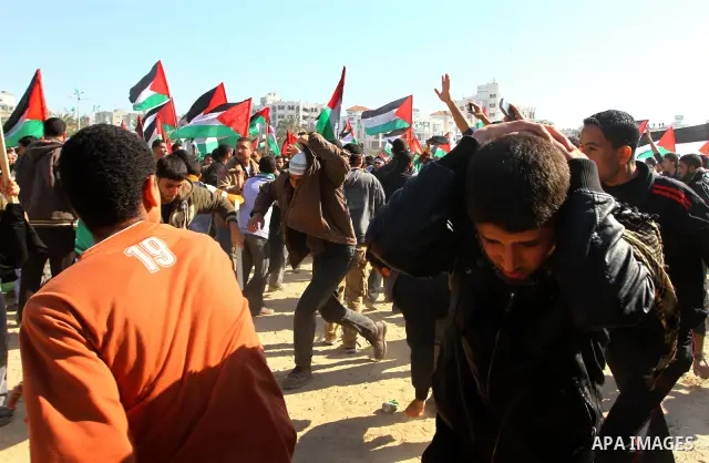 Palestinian demonstrators run during brief clashes between Hamas supporters and protestors supporting other Palestinian factions, during a rally calling for Palestinian political unity between Gaza's Hamas rulers and the...