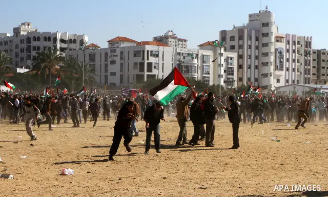 Palestinian demonstrators run during brief clashes between Hamas supporters and protestors supporting other Palestinian factions, during a rally calling for Palestinian political unity between Gaza's Hamas rulers and the...