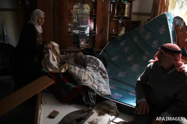 Palestinians examine their damaged room after an Israeli army raid in the West Bank village of Awarta, Wednesday, March 16, 2011. The Israeli army operated in the village in previous days following an attack in a nearby...