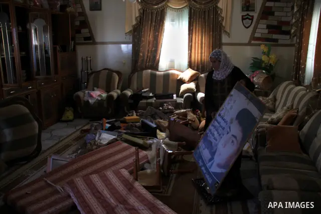 Palestinians examine their damaged room after an Israeli army raid in the West Bank village of Awarta, Wednesday, March 16, 2011. The Israeli army operated in the village in previous days following an attack in a nearby...