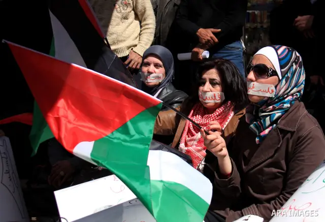 Palestinian demonastrators wave flags and chant slogans in a rally calling for a reconciliation between Fatah in west bank and hamas in Gaza strip., March 16, 2011. Photo by Wagdi Eshtayah