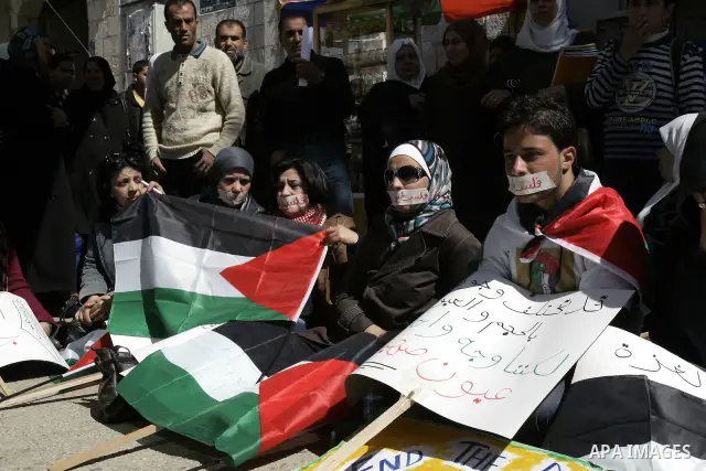Palestinian demonastrators wave flags and chant slogans in a rally calling for a reconciliation between Fatah in west bank and hamas in Gaza strip., March 16, 2011. Photo by Wagdi Eshtayah