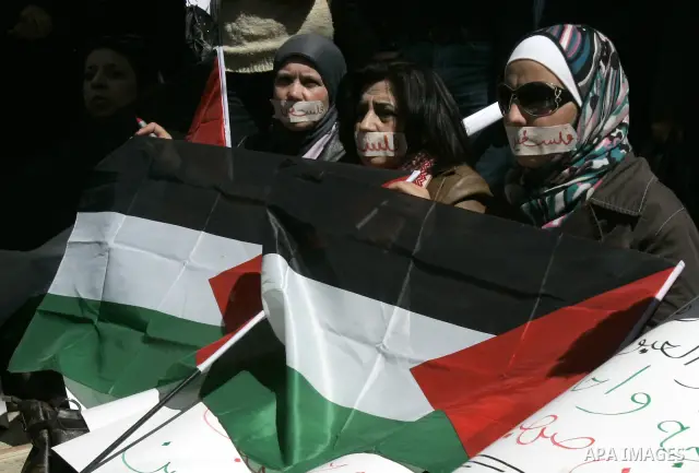 Palestinian demonastrators wave flags and chant slogans in a rally calling for a reconciliation between Fatah in west bank and hamas in Gaza strip., March 16, 2011. Photo by Wagdi Eshtayah
