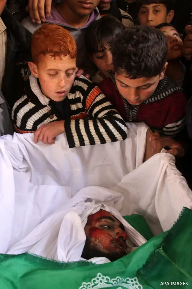 Palestinian relatives of Hamas militant Ghassan Abu Amr, 27, mourn over his body during his funeral in Gaza City on March 16, 2011 after he was killed earlier in the day along with another miltant in an Israeli air raied...