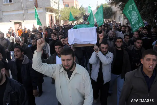 Palestinian relatives of Hamas militant Ghassan Abu Amr, 27, mourn over his body during his funeral in Gaza City on March 16, 2011 after he was killed earlier in the day along with another miltant in an Israeli air raied...