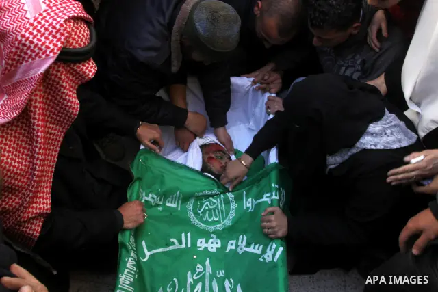 Palestinian relatives of Hamas militant Ghassan Abu Amr, 27, mourn over his body during his funeral in Gaza City on March 16, 2011 after he was killed earlier in the day along with another miltant in an Israeli air raied...