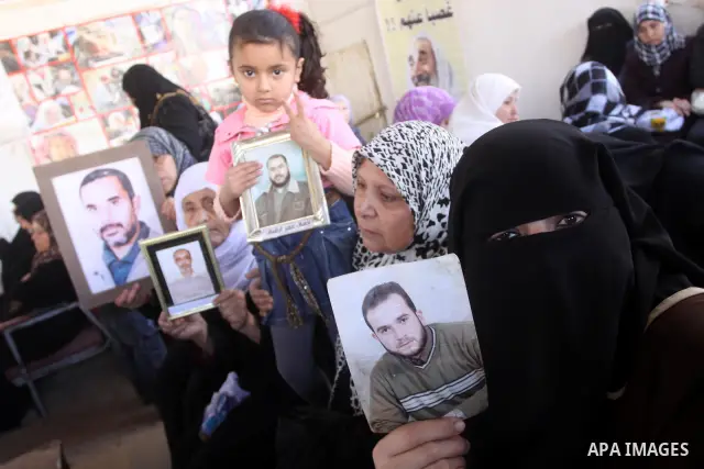Palestinian women hold pictures of jailed relatives during a protest calling for the release of Palestinian prisoners from Israeli jails in Gaza City March 17,2011 . Photo by Mohammed Asad