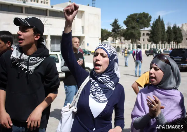 Palestinians chant slogans as they set up a tent in Manager Square in front of the Church of the Nativity in the West Bank city of Bethlehem on March 18, 2011 during a protest calling for Palestinian political unity betw...