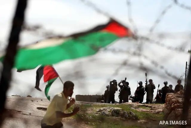 Israeli soldiers stand guard during clashes with Palestinian youths following a weekly demonstration against Israel's separation barrier in the West Bank village of Bilin on March 18, 2011. Photo by Issam Rimawi