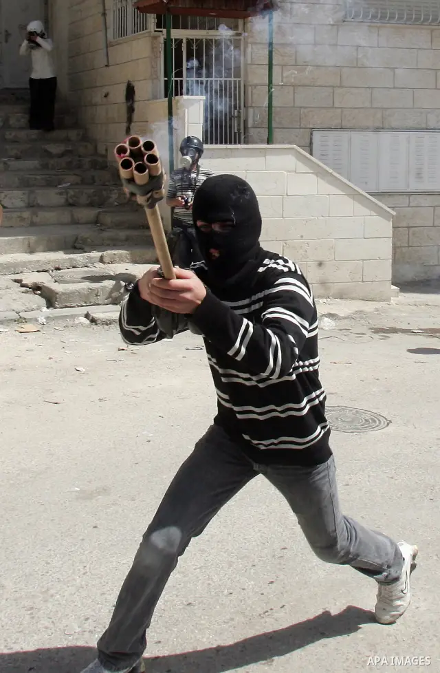 A Palestinian demonstrator shoots fireworks during clashes with Israeli soldiers in Jerusalem's neighbourhood of silwan on March 18, 2011. Photo by Mahfouz Abu Turk