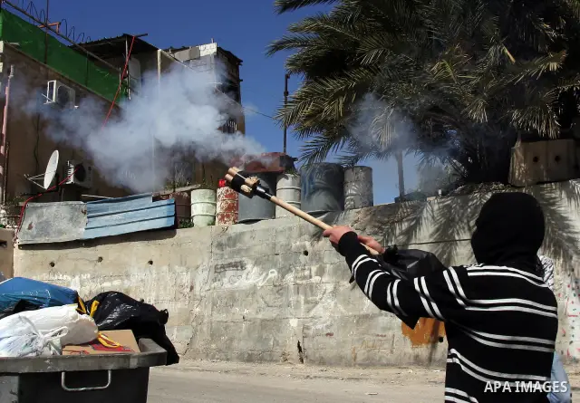 A Palestinian demonstrator shoots fireworks during clashes with Israeli soldiers in Jerusalem's neighbourhood of silwan on March 18, 2011. Photo by Mahfouz Abu Turk