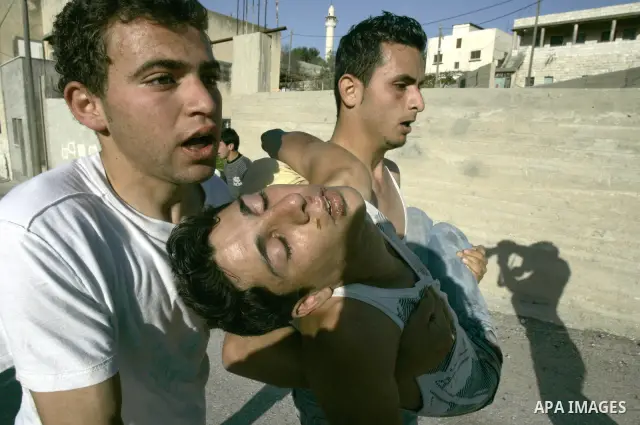 Palestinians carry an injured youth during clashes with Israeli settlers in the West Bank village of Yasuf south of Nablus, Friday, March 18, 2011. Photo by Wagdi Eshtayah
