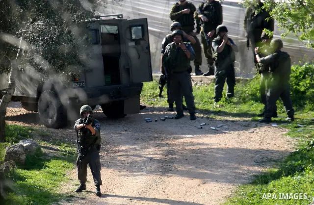 Israeli soldiers take position during clashes between Israeli settlers and Palestinian youths in the West Bank village of Yasuf south of Nablus, Friday, March 18, 2011. Photo by Wagdi Eshtayah