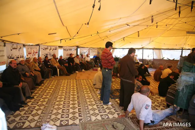 Palestinian demonstrators attend Friday prayers at the protest tent in Jerusalem's neighbourhood of silwan on March 18, 2011. Photo by Sliman Khader