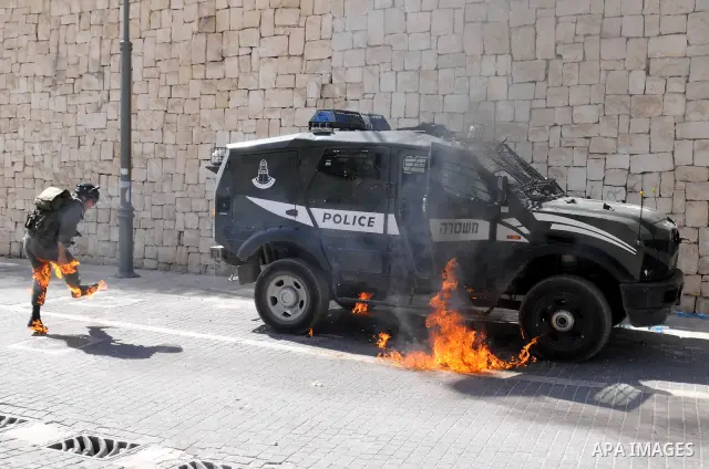 An Israeli border police tries to escape from a Molotov cocktail thrown by Palestinian youths, during clashes in the east Jerusalem neighborhood of Silwan, Friday, March 18, 2011. Photo by Sliman Khader