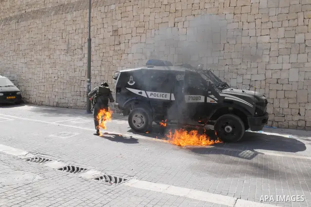 An Israeli border police tries to escape from a Molotov cocktail thrown by Palestinian youths, during clashes in the east Jerusalem neighborhood of Silwan, Friday, March 18, 2011. Photo by Sliman Khader
