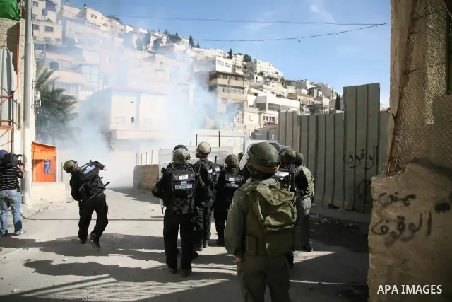 Israeli soldiers fire tear gas canisters towards Palestinian demonstrators during the clashes after Friday prayers in Jerusalem's neighbourhood of silwan on March 18, 2011. Photo by Sliman Khader