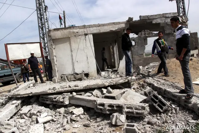 Palestinians look at the damage after Israeli strikes on the Gaza Strip. Israeli strikes on the Gaza Strip wounded five Hamas security officers and a boy on Saturday after militants launched mortar bombs into Israel, lig...