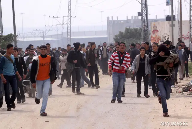 Palestinians run away for a cover during Israeli strikes on the Gaza Strip. Israeli strikes on the Gaza Strip wounded five Hamas security officers and a boy on Saturday after militants launched mortar bombs into Israel,...