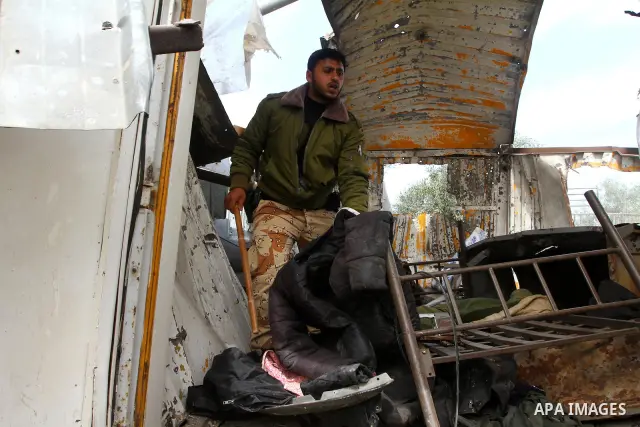 A Palestinian member of the Hamas security forces surveys the scene after Israeli strikes on the Gaza Strip . Israeli strikes on the Gaza Strip wounded five Hamas security officers and a boy on Saturday after militants l...