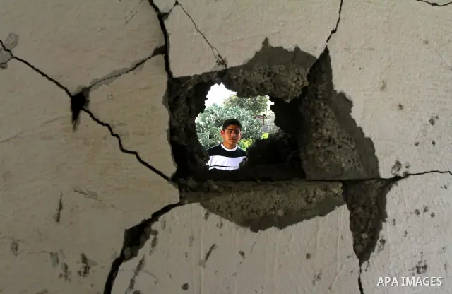 Palestinian looks at the damage after Israeli strikes on the Gaza Strip. Israeli strikes on the Gaza Strip wounded five Hamas security officers and a boy on Saturday after militants launched mortar bombs into Israel, lig...