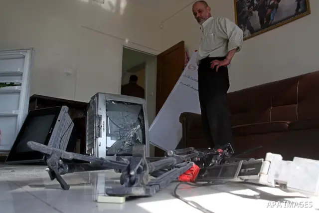 Palestinian journalists inspect the damages at Reuters office after Palestinian security forces raid the office in Gaza City on March 19,2011. Photo by Mohammed Asad