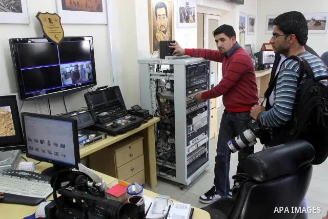 Palestinian journalists inspect the damages at Reuters office after Palestinian security forces raid the office in Gaza City on March 19,2011. Photo by Mohammed Asad