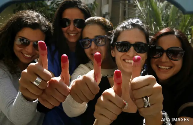 Egyptians show their inked fingers after voting for the referendum on constitutional amendments in Cairo, capital of Egypt. Egyptians started voting on Saturday morning to decide on constitutional amendments aimed at ens...