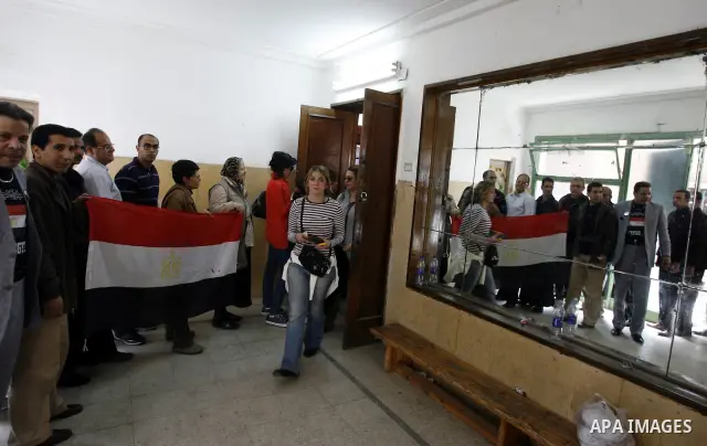 Egyptians queue to cast their vote during a national referendum, at a school in Cairo, March 19, 2011. Egyptians flocked to the polls on Saturday in a historic referendum on changes to the constitution. The amendments we...