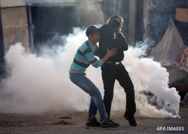 Israeli Border Police fire tear gas towards Palestinian stone throwers during a clash in the Shuafat Refugee Camp, north of Jerusalem, in the West Bank, 19 March 2011. Palestinians clashed with Israeli forces in several...