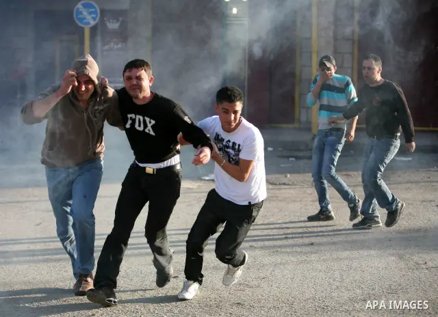 Israeli Border Police fire tear gas towards Palestinian stone throwers during a clash in the Shuafat Refugee Camp, north of Jerusalem, in the West Bank, 19 March 2011. Palestinians clashed with Israeli forces in several...