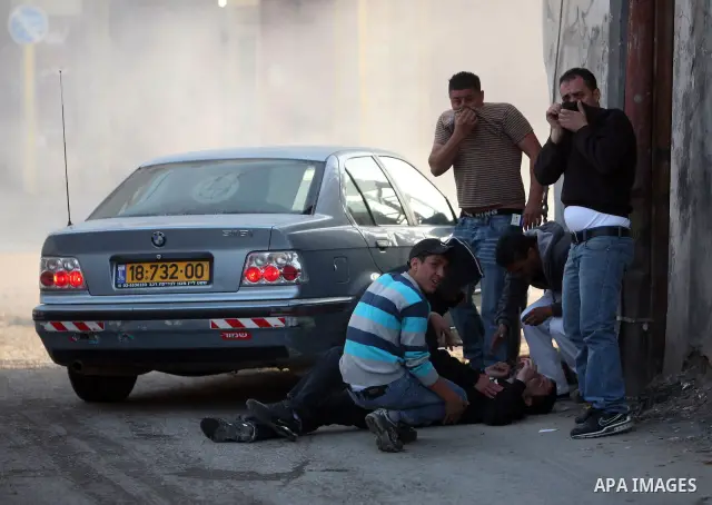 Israeli Border Police fire tear gas towards Palestinian stone throwers during a clash in the Shuafat Refugee Camp, north of Jerusalem, in the West Bank, 19 March 2011. Palestinians clashed with Israeli forces in several...