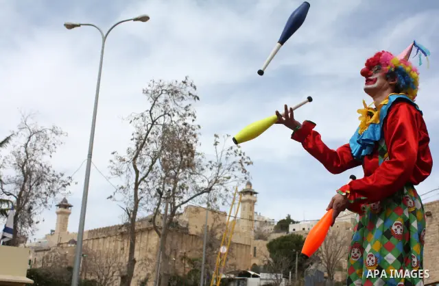 Israelis parade during their celebration of the Jewish holiday of Purim in the divided West Bank city of Hebron, on 20 March 2011. The joyful Jewish holiday of Purim celebrates the Jews' salvation from genocide in ancien...