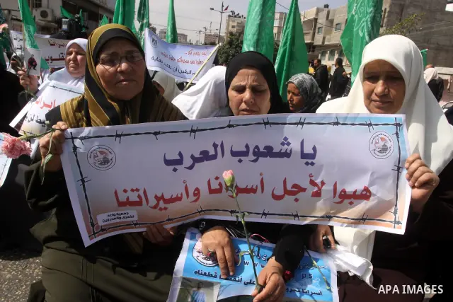 Palestinian women hold pictures of jailed relatives during a protest calling for the release of Palestinian prisoners from Israeli jails. Gaza city on March 21,2011 . Photo by Mohammed Asad