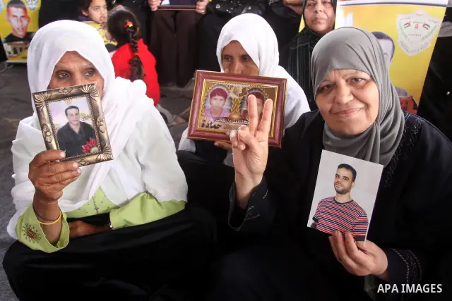 Palestinian women hold pictures of jailed relatives during a protest calling for the release of Palestinian prisoners from Israeli jails. Gaza city on March 21,2011 . Photo by Mohammed Asad